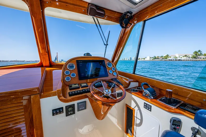 Gracious Yacht Photos Pics Helm of 2018 Hinckley Picnic Boat 37 MKIII with wooden dashboard and ocean view.