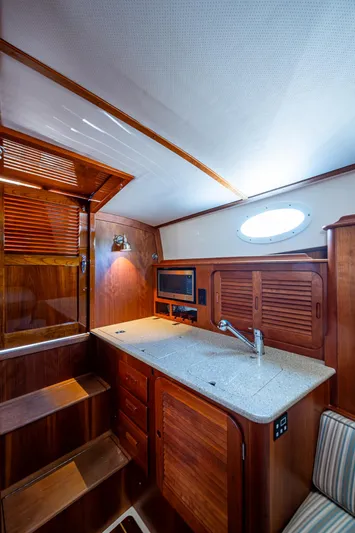 Gracious Yacht Photos Pics 2018 Hinckley Picnic Boat 37 MKIII interior with wooden cabinetry and modern amenities.