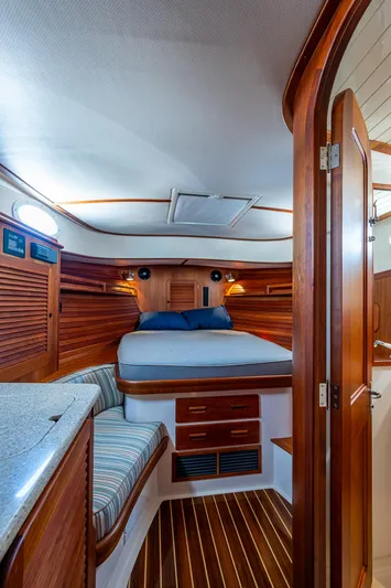 Gracious Yacht Photos Pics Interior of 2018 Hinckley Picnic Boat 37 MKIII with cozy wooden cabin and bed.