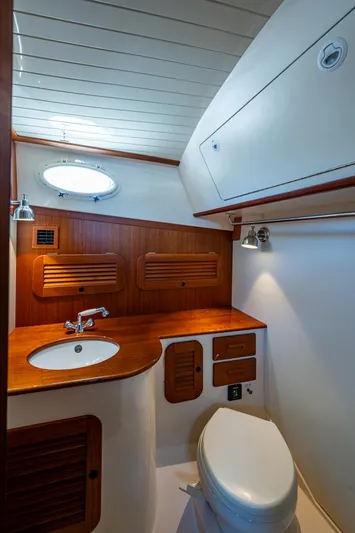 Gracious Yacht Photos Pics 2018 Hinckley Picnic Boat 37 MKIII bathroom with wood accents and modern fixtures.