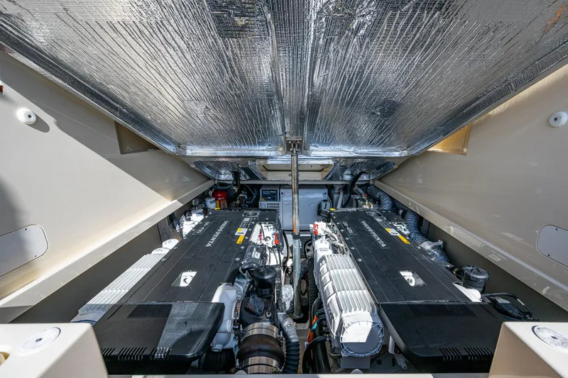 Gracious Yacht Photos Pics Engine compartment of 2018 Hinckley Picnic Boat 37 MKIII, showcasing dual engines and insulated ceiling.