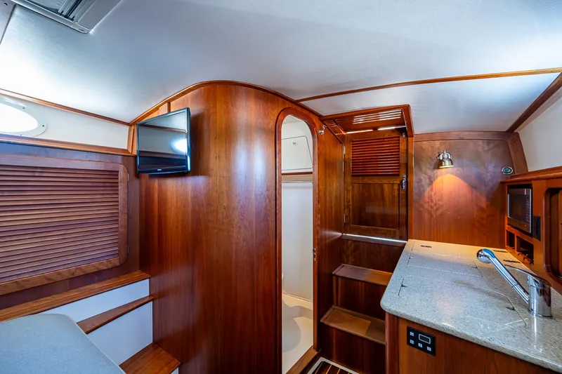 Gracious Yacht Photos Pics Interior of 2018 Hinckley Picnic Boat 37 MKIII with wood finish and modern amenities.
