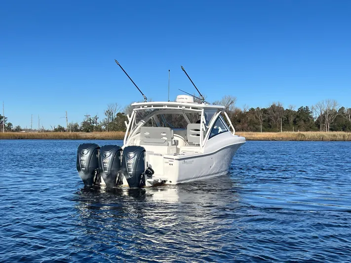  Yacht Photos Pics 2023 Albemarle 31 Dual Console boat on calm water with triple outboard engines.