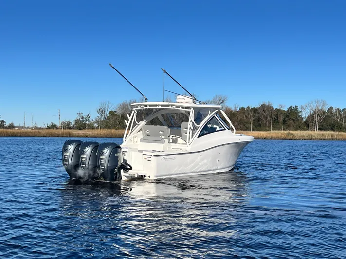  Yacht Photos Pics 2023 Albemarle 31 Dual Console boat on calm water with triple outboard engines.