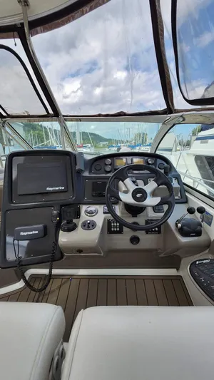  Yacht Photos Pics 2008 Cruisers Yachts 420 Express helm with modern navigation equipment and steering wheel.