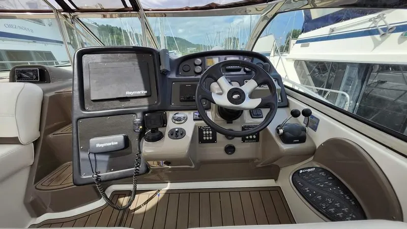  Yacht Photos Pics 2008 Cruisers Yachts 420 Express helm with steering wheel and navigation equipment.