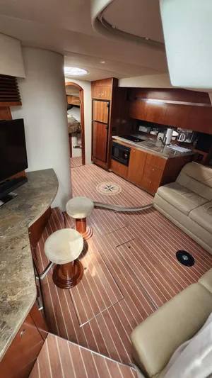  Yacht Photos Pics 2008 Cruisers Yachts 420 Express interior with kitchen, seating, and wood flooring.