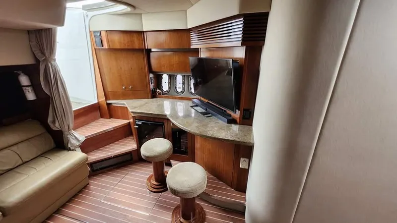  Yacht Photos Pics 2008 Cruisers Yachts 420 Express interior with wood finish, seating, and entertainment area.