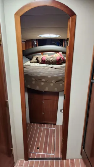  Yacht Photos Pics Interior cabin of 2008 Cruisers Yachts 420 Express with cozy bed and wooden accents.