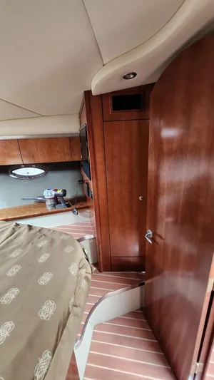  Yacht Photos Pics Interior of 2008 Cruisers Yachts 420 Express with wood paneling and cozy cabin space.