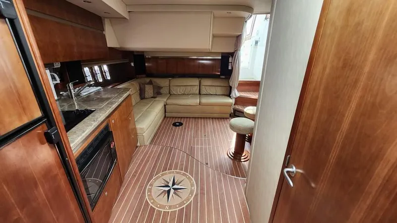  Yacht Photos Pics 2008 Cruisers Yachts 420 Express interior with kitchen, seating area, and wooden flooring.