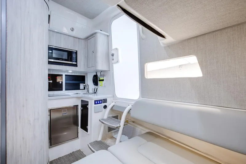  Yacht Photos Pics 2021 Regulator 41 interior with modern kitchenette and seating area.