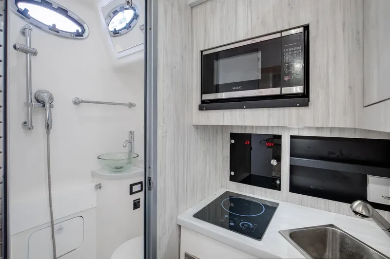  Yacht Photos Pics Modern 2021 Regulator 41 yacht interior with kitchenette and bathroom amenities.