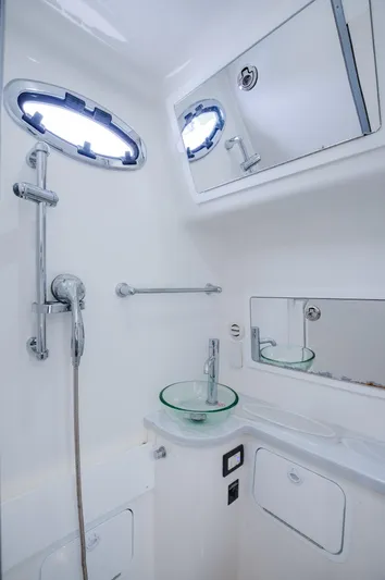  Yacht Photos Pics 2021 Regulator 41 boat bathroom with modern fixtures and glass sink.