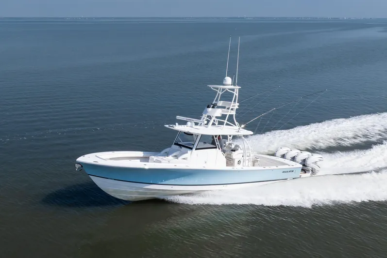  Yacht Photos Pics 2021 Regulator 41 boat cruising on open water, showcasing sleek design and powerful engines.