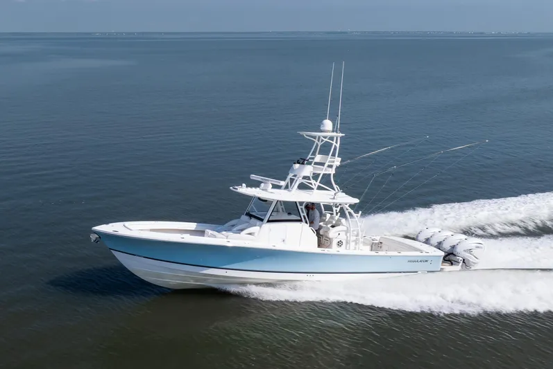  Yacht Photos Pics 2021 Regulator 41 boat cruising on open water, showcasing sleek design and powerful engines.