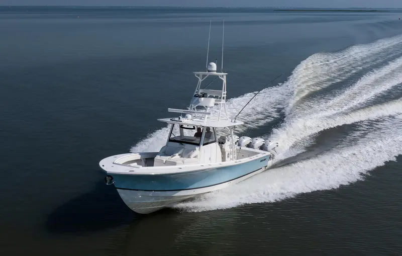  Yacht Photos Pics 2021 Regulator 41 boat cruising on open water, creating a dynamic wake.