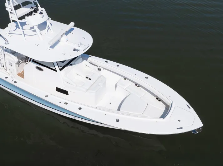  Yacht Photos Pics 2021 Regulator 41 boat on calm water, showcasing sleek design and spacious deck.