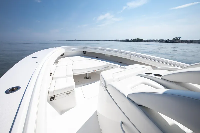  Yacht Photos Pics 2021 Regulator 41 boat with spacious seating on calm water under clear sky.