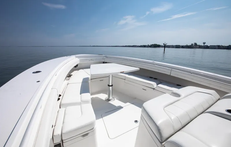  Yacht Photos Pics 2021 Regulator 41 boat with spacious seating and table on calm water.