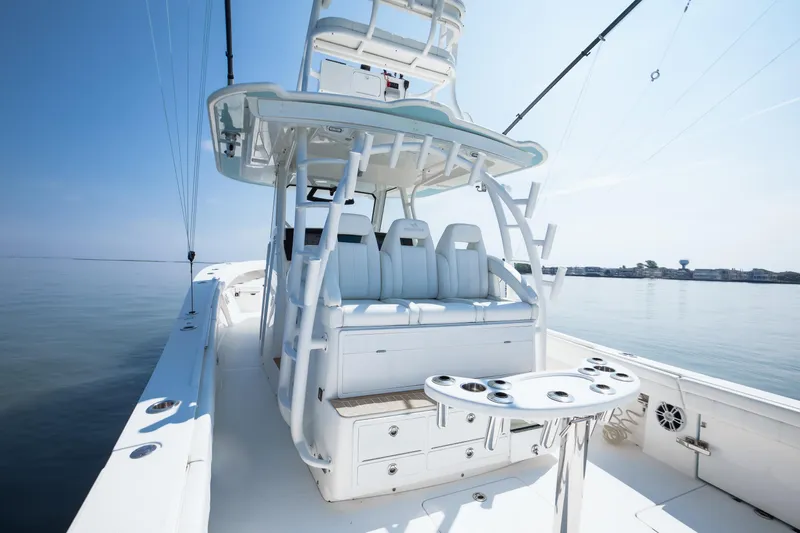  Yacht Photos Pics 2021 Regulator 41 boat with sleek seating and fishing rod holders on calm water.