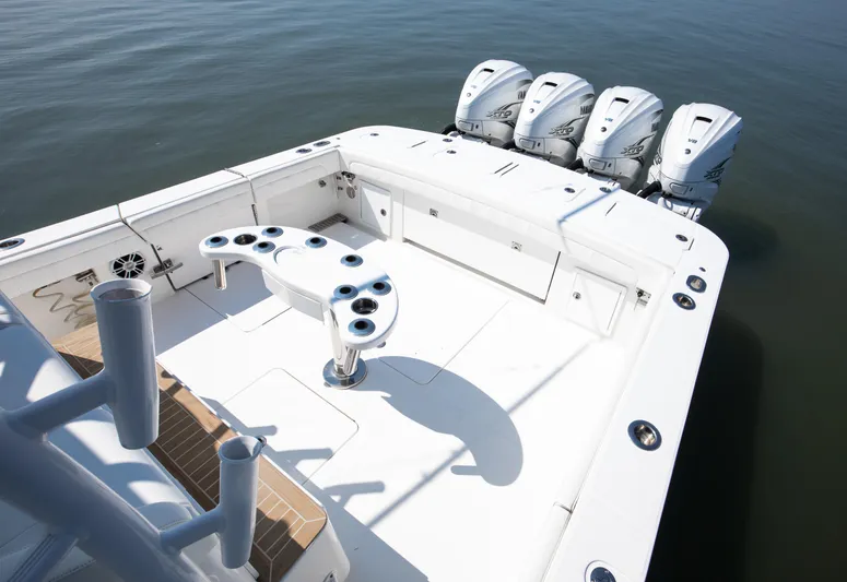  Yacht Photos Pics 2021 Regulator 41 boat deck with quad outboard engines on calm water.