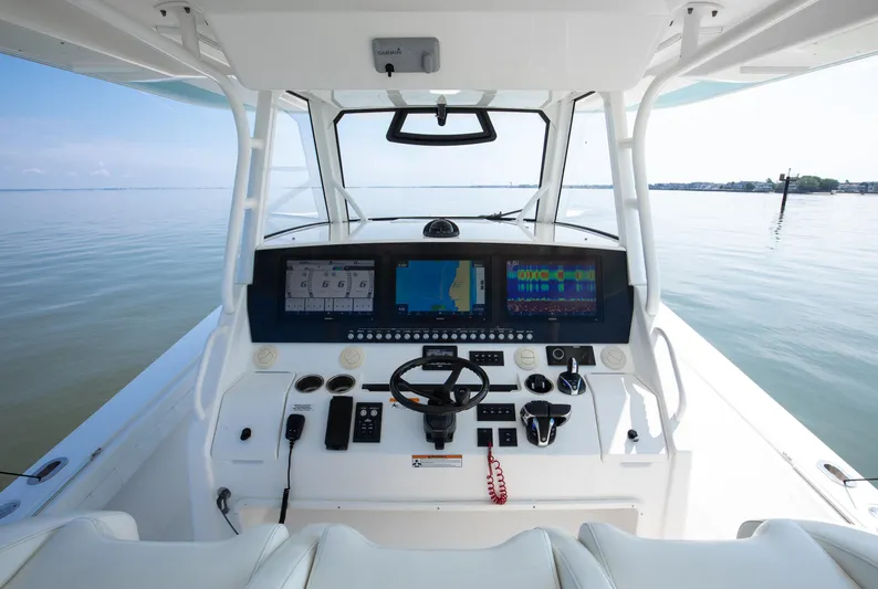  Yacht Photos Pics 2021 Regulator 41 boat cockpit with advanced navigation displays on calm water.