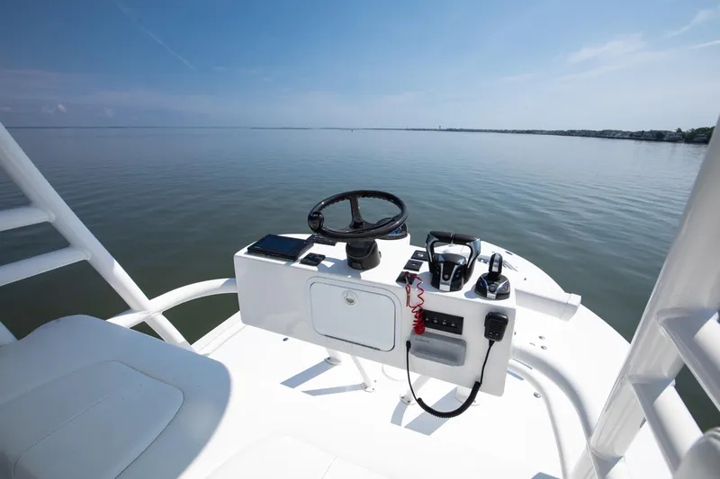  Yacht Photos Pics 2021 Regulator 41 boat helm with steering wheel and controls on calm water.