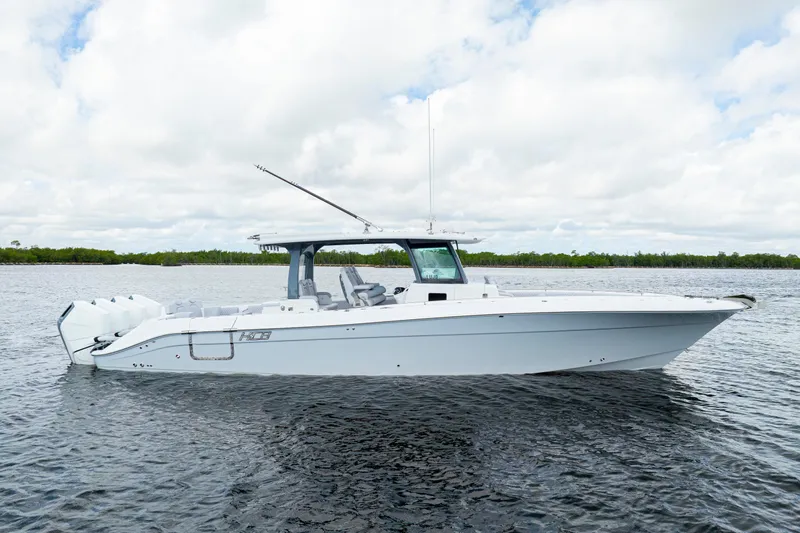  Yacht Photos Pics 2026 HCB 42 Lujo boat on calm water under cloudy sky.