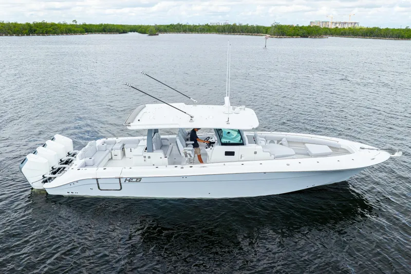  Yacht Photos Pics 2026 HCB 42 Lujo boat on calm water, featuring sleek design and multiple engines.