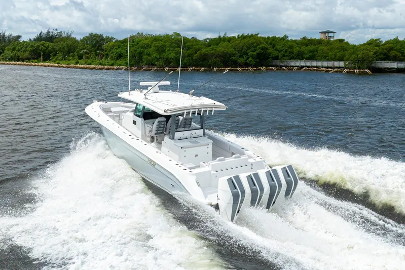  Yacht Photos Pics 2026 HCB 42 Lujo boat cruising on a river with lush greenery.