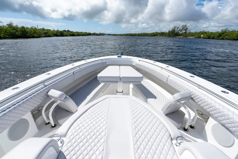  Yacht Photos Pics 2026 HCB 42 Lujo luxury boat interior with white quilted seating on a calm waterway.