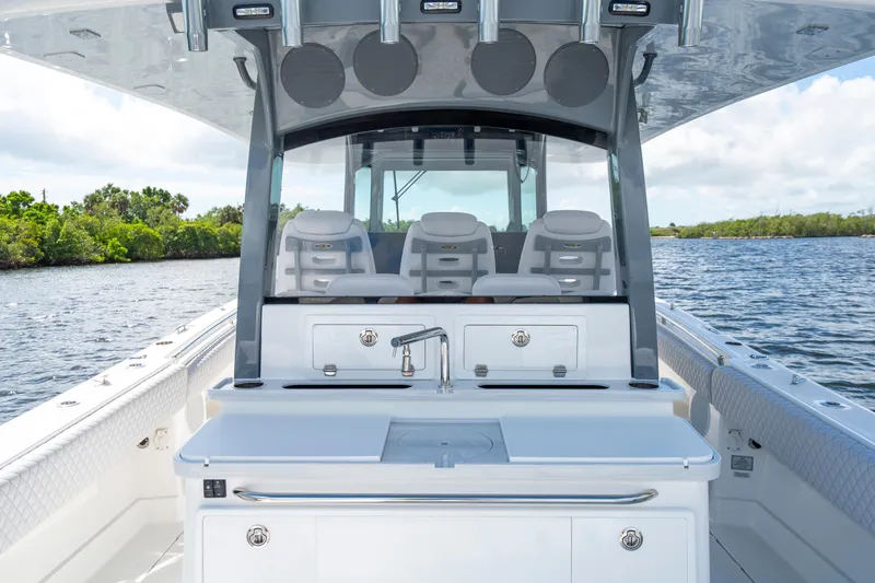  Yacht Photos Pics 2026 HCB 42 Lujo boat interior with seating and sleek design on a calm waterway.