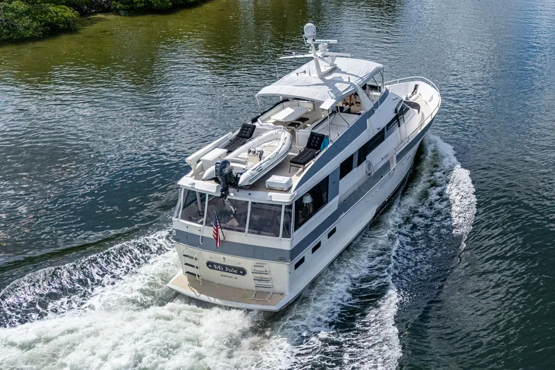 Mi Jule Yacht Photos Pics 1991 Viking 65 Motor Yacht cruising on a calm waterway, rear view.