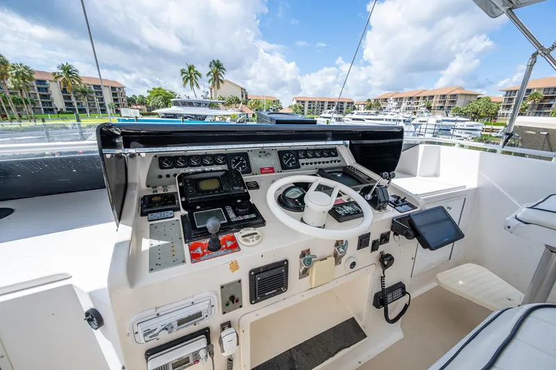 Mi Jule Yacht Photos Pics Cockpit of 1991 Viking 65 Motor Yacht with navigation controls and marina view.