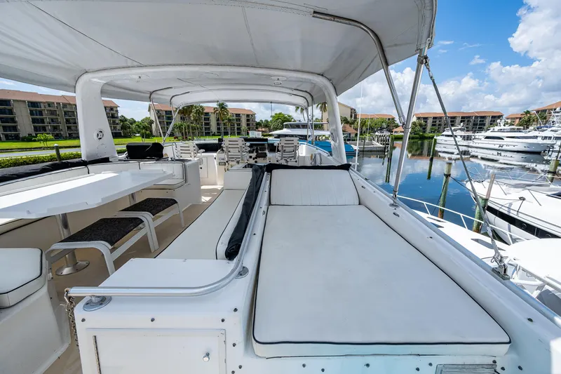 Mi Jule Yacht Photos Pics 1991 Viking 65 Motor Yacht deck with seating, docked in marina under blue sky.