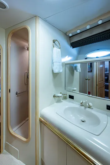 Mi Jule Yacht Photos Pics Bathroom interior of 1991 Viking 65 Motor Yacht with sink, mirror, and shower.
