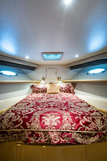 Mi Jule Yacht Photos Pics Luxurious bedroom in 1991 Viking 65 Motor Yacht with elegant red bedding and ambient lighting.