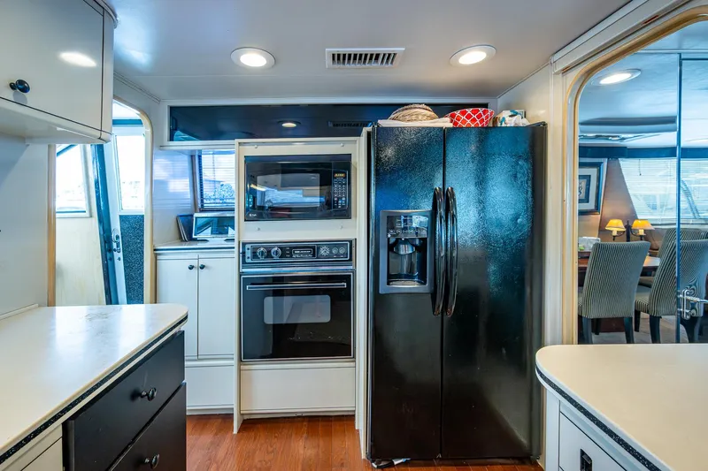 Mi Jule Yacht Photos Pics Kitchen interior of 1991 Viking 65 Motor Yacht with modern appliances and wood flooring.