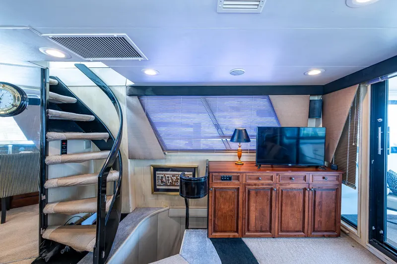 Mi Jule Yacht Photos Pics Luxurious interior of 1991 Viking 65 Motor Yacht with spiral staircase and entertainment center.