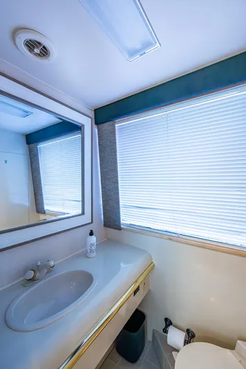 Mi Jule Yacht Photos Pics Bathroom interior of 1991 Viking 65 Motor Yacht with sink and window blinds.