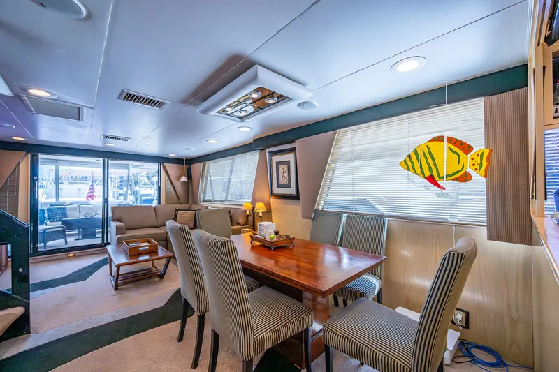 Mi Jule Yacht Photos Pics Interior of 1991 Viking 65 Motor Yacht with dining area and striped chairs.