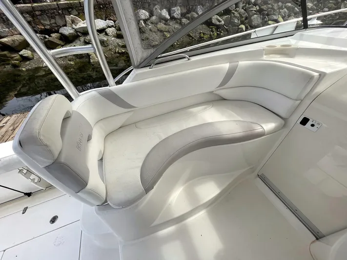  Yacht Photos Pics 2006 Boston Whaler 305 Conquest boat interior with white cushioned seating.