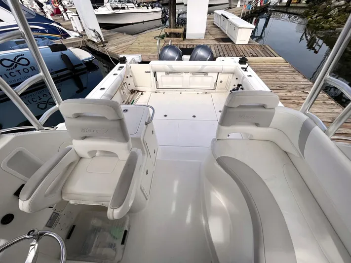  Yacht Photos Pics 2006 Boston Whaler 305 Conquest boat interior with seating and dock view.