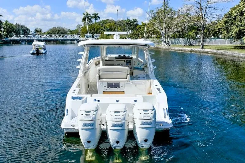 350 Realm Yacht Photos Pics 2019 Boston Whaler 350 Realm with triple outboard engines on a scenic waterway.