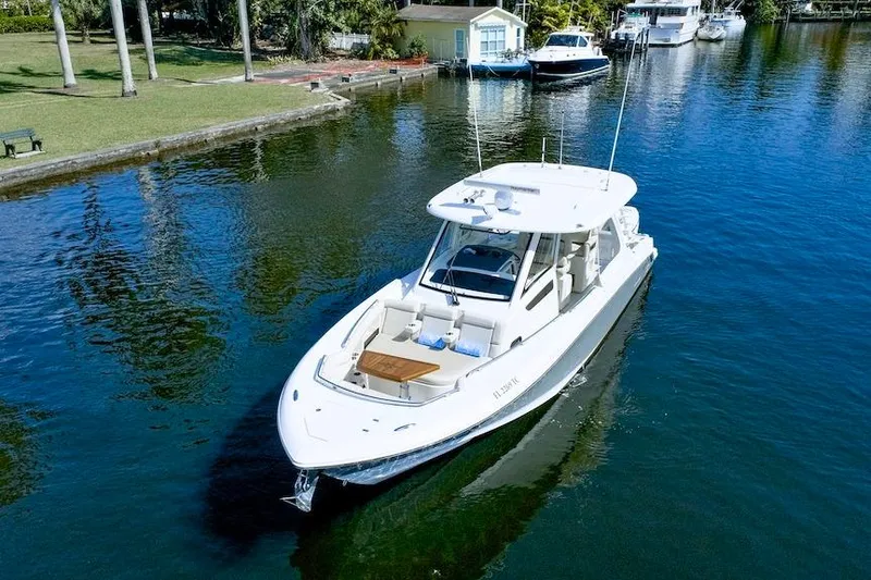350 Realm Yacht Photos Pics 2019 Boston Whaler 350 Realm boat cruising on a serene waterway.