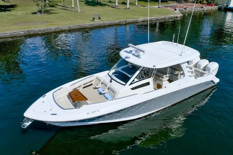 350 Realm Yacht Photos Pics 2019 Boston Whaler 350 Realm boat on calm water, showcasing sleek design and luxury features.