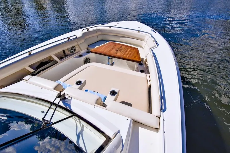 350 Realm Yacht Photos Pics 2019 Boston Whaler 350 Realm boat interior with seating and table on water.