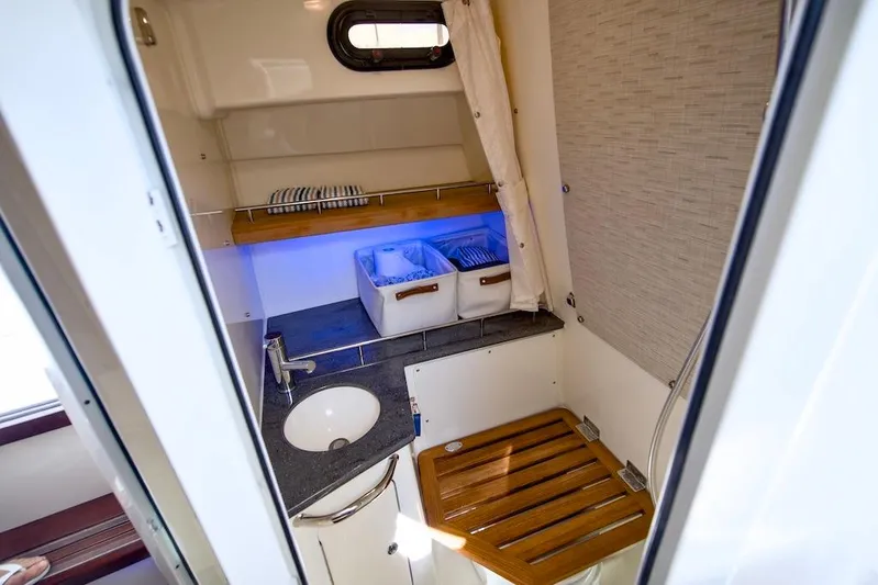350 Realm Yacht Photos Pics Interior of 2019 Boston Whaler 350 Realm, featuring a compact sink and storage area.