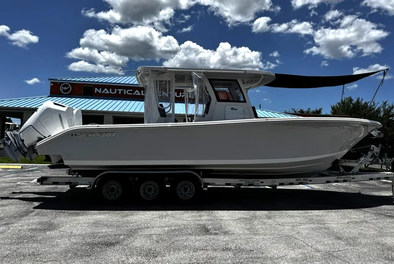  Yacht Photos Pics 2024 Sea Pro 322 DLX boat on trailer under blue sky at Nautical Ventures.